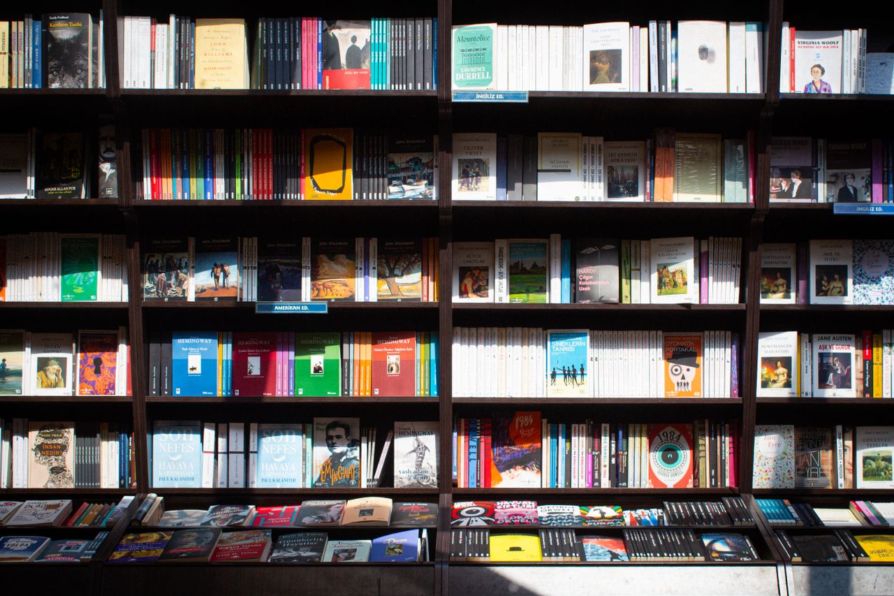 our-experience Wide array of books on a shelf in a cozy bookstore in Ankara, Türkiye.