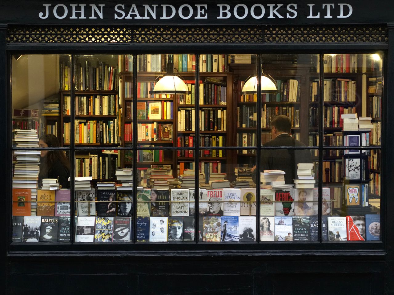 about-img A cozy London bookstore showcasing various books through a classic window display.